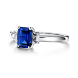 3 CT. Emerald Cut Blue Sapphire and White Sapphire Three Stone Ring